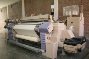 Weaving looms in a textile mill. Weaving looms in a textile mill.