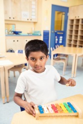 A child playing a xylophone. A child playing a xylophone.