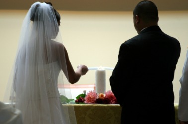 A couple light a unity candle. A couple light a unity candle.