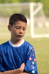 A boy bummed because his team lost. A boy bummed because his team lost.