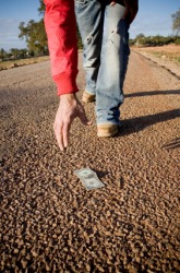 A man finds money on the street. A man finds money on the street.