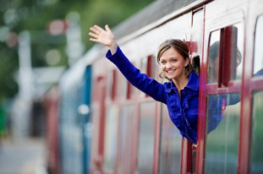 A woman waves adieu. A woman waves adieu.