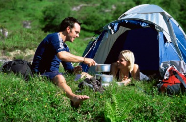 A couple equipped for camping. A couple equipped for camping.