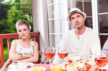 A couple at a lackluster party. A couple at a lackluster party.