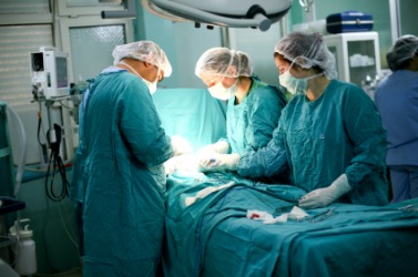 A medical team performs surgery. A medical team performs surgery.