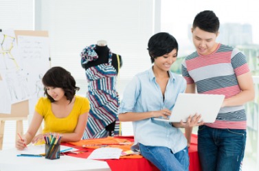 People engaged in the business of dressmaking. People engaged in the business of dressmaking.