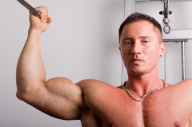 A man flexes his biceps. A man flexes his biceps.