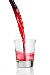 Red liquid being poured into a glasss. Red liquid being poured into a glasss.