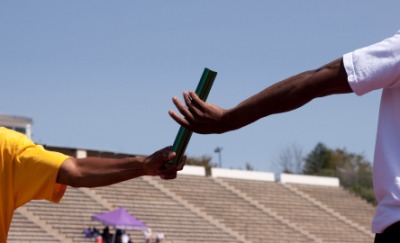 Athletes running a relay race. Athletes running a relay race.