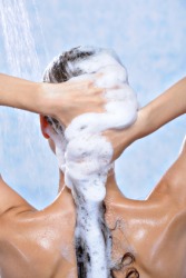 A woman uses shampoo to wash her hair. A woman uses shampoo to wash her hair.