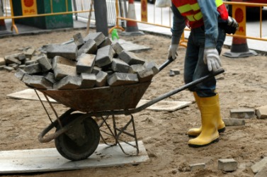A wheelbarrow full of bricks. A wheelbarrow full of bricks.