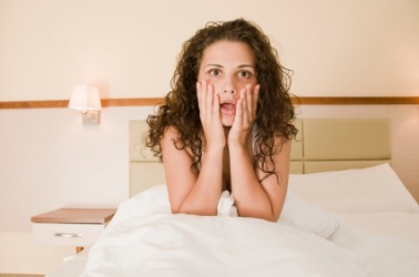 A woman awakes from a bad dream. A woman awakes from a bad dream.