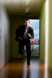 A man dashes down the hall. A man dashes down the hall.