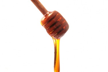 Honey oozes from a dipper. Honey oozes from a dipper.