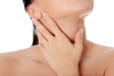 A woman with her hand to her throat. A woman with her hand to her throat.