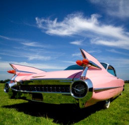 The tail fins of a 1959 pink Cadillac. The tail fins of a 1959 pink Cadillac.