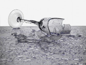 A glass has fallen to the ground causing it to break. A glass has fallen to the ground causing it to break.