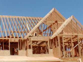 The frame of a new house under construction. The frame of a new house under construction.