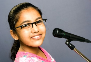 A girl about to speak into a microphone. A girl about to speak into a microphone.