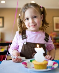 A little girl celebrating her birthday. A little girl celebrating her birthday.