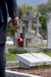 A widower at his wife's grave. A widower at his wife's grave.
