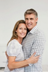 A man hugs his wife. A man hugs his wife.
