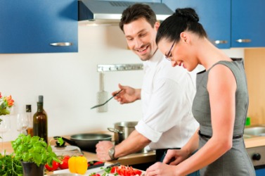 A couple cook a meal. A couple cook a meal.