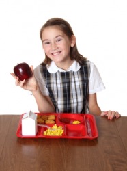 A girl eats her school lunch. A girl eats her school lunch.