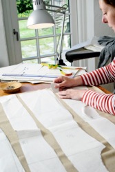 A dressmaker using a pattern. A dressmaker using a pattern.
