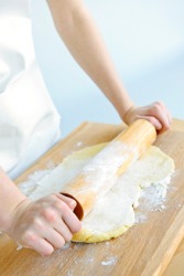 A rolling pin is used to roll out cookie dough. A rolling pin is used to roll out cookie dough.
