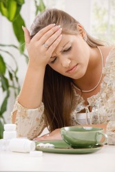 This woman hopes these things will alleviate her headache. This woman hopes these things will alleviate her headache.