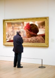 A man scrutinizes a picture. A man scrutinizes a picture.