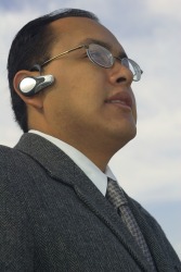 A man using a Bluetooth headset. A man using a Bluetooth headset.