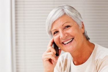 A woman uses her phone to call a friend. A woman uses her phone to call a friend.