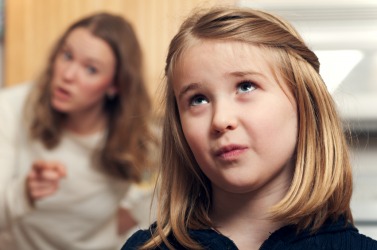 A mother chides her daughter. A mother chides her daughter.