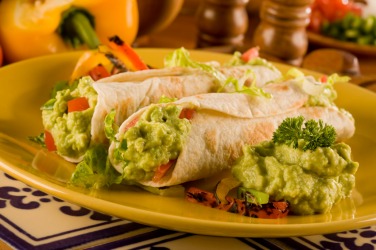 Burritos served with guac. Burritos served with guac.