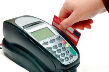 A credit card is being used to make a payment. A credit card is being used to make a payment.