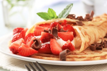 Crepes served with strawberries. Crepes served with strawberries.