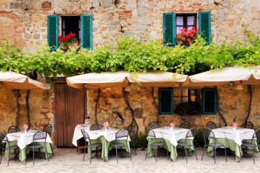 Outdoor seating at a trattoria. Outdoor seating at a trattoria.