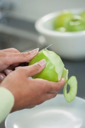 She pares the apples for her homemade apple pie recipe. She pares the apples for her homemade apple pie recipe.