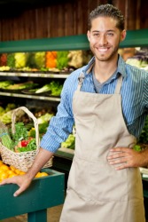 The young man works part-time at the grocery store because he also takes college classes. The young man works part-time at the grocery store because he also takes college classes.