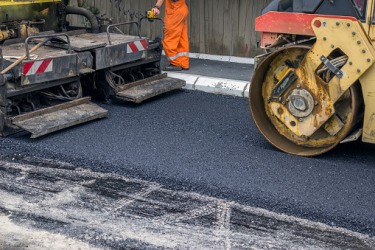 A road being paved with asphalt. A road being paved with asphalt.