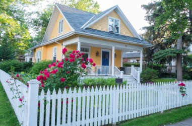 A white picket fence surrounds the perimeter of the house. A white picket fence surrounds the perimeter of the house.