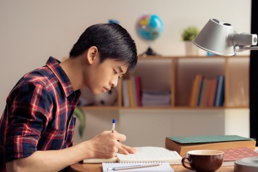 A student is perusing his notes to prepare for the test. A student is perusing his notes to prepare for the test.