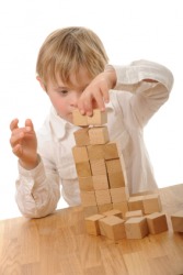 A child playing with wooden blocks. A child playing with wooden blocks.