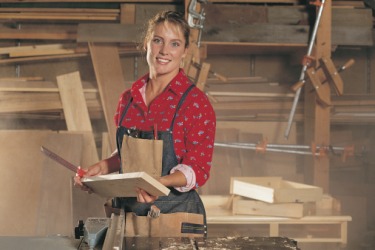 The plier is building a custom furniture piece for a client in her shop. The plier is building a custom furniture piece for a client in her shop.