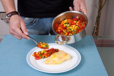 A polloterian preparing a dinner of fish and vegetables. A polloterian preparing a dinner of fish and vegetables.