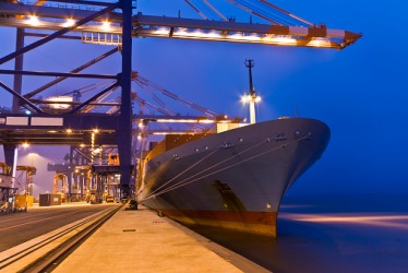 A cargo ship docked in a port. A cargo ship docked in a port.