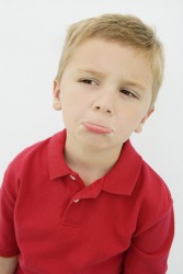 A young boy acting pouty. A young boy acting pouty.