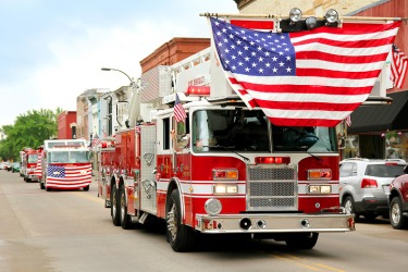 A procession of fire trucks in a small town parade. A procession of fire trucks in a small town parade.